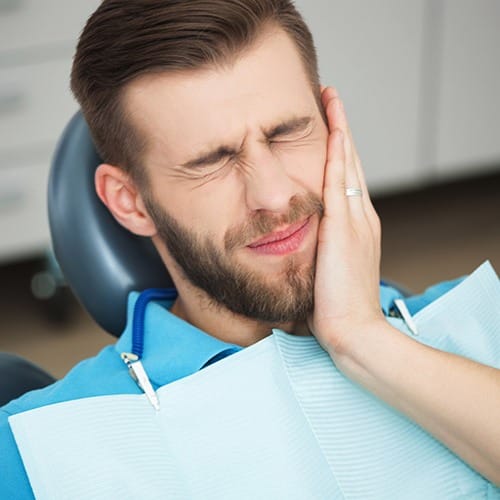 Man in pain before his emergency dentistry visit
