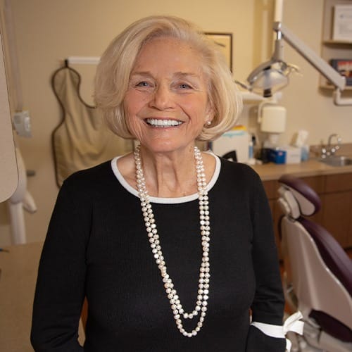 Woman smiling after tooth replacement