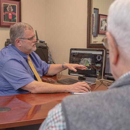 Dentist showing patient a gum grafting treatment plan