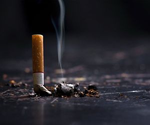 Extinguished cigarette smolders