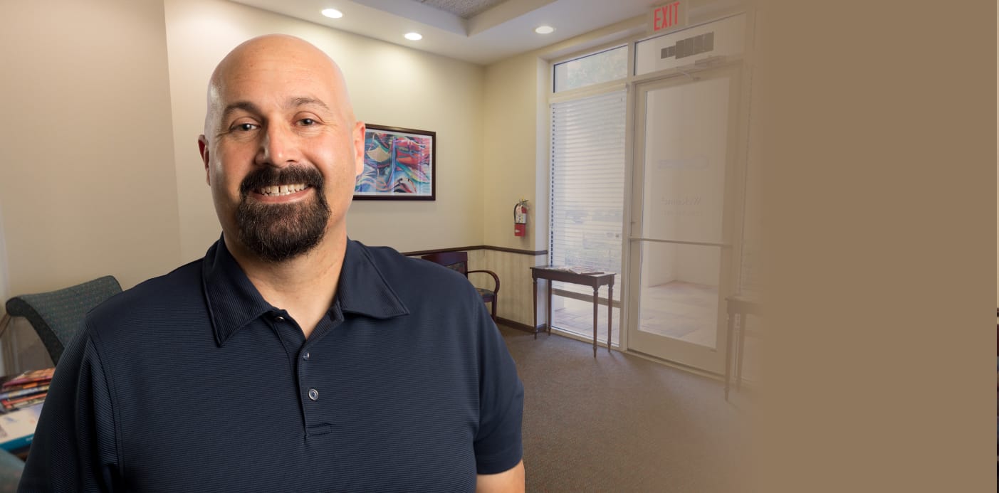 Real patient Joel smiling after dental implant tooth replacement