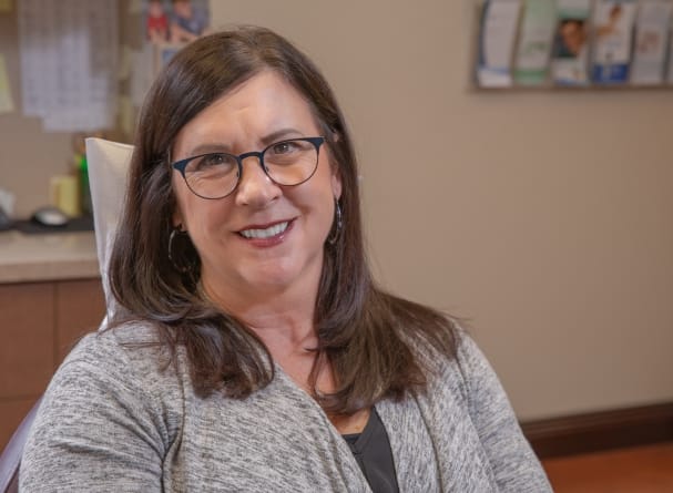 Dental patient smiling after preventive dentistry appointment