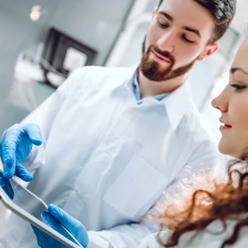 Dentist and patient discussing different dental implant options