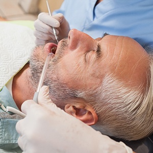 Man with grey hair in dental chair during appointment