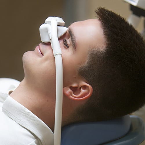 Patient with inhaled sedation nose mask in place