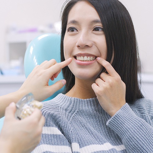 woman talking to dentist about cost of veneers in North Naples 