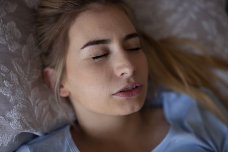 a young female grinding her teeth while asleep