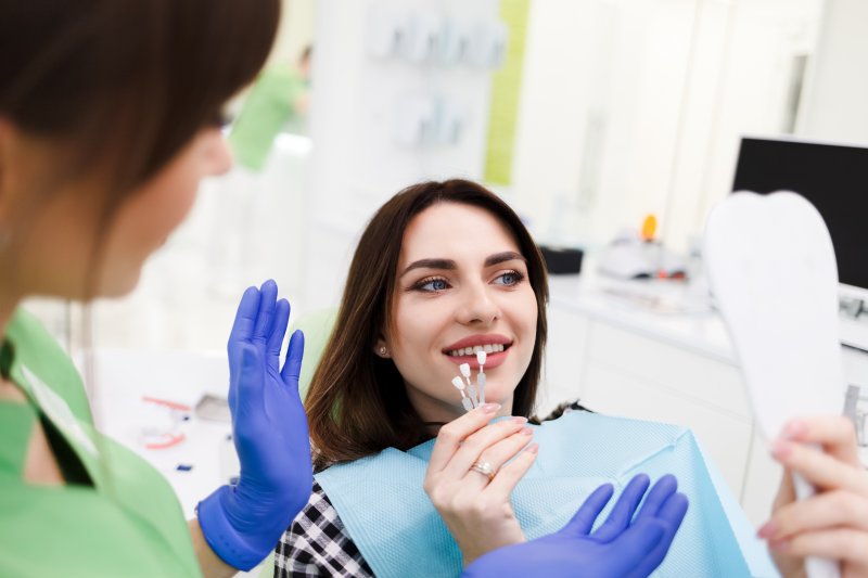 Patient deciding whether to get veneers or crowns